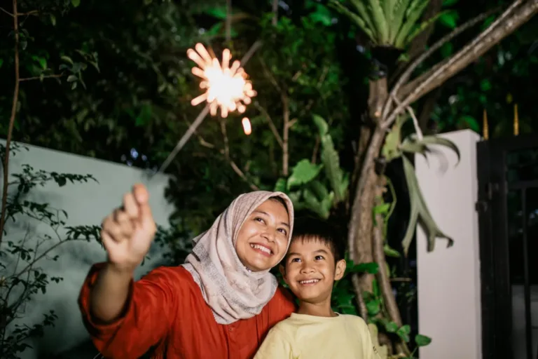 woman and young boy with a sparkler on the 4th of July